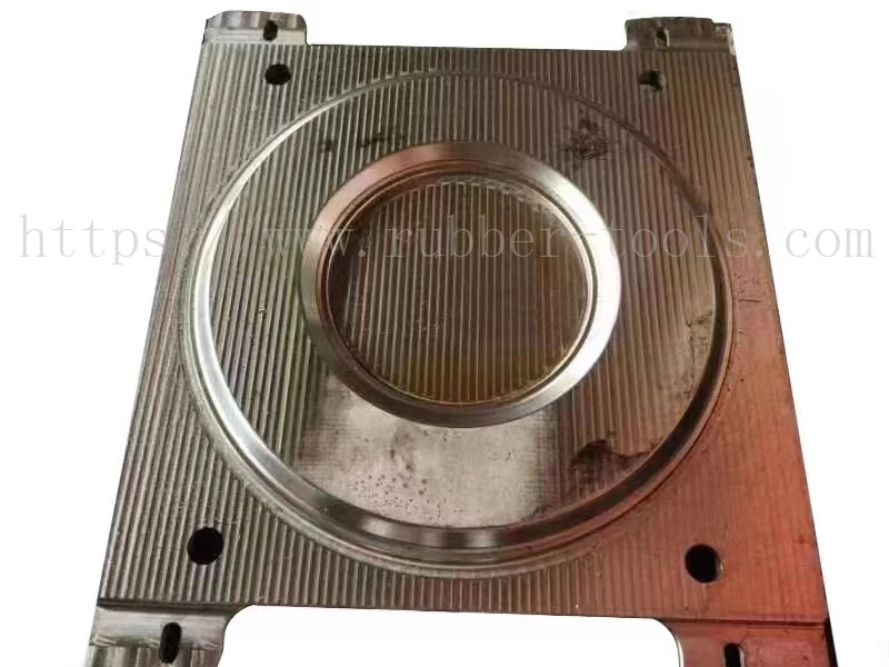Polished steel rubber mould half with a circular cavity