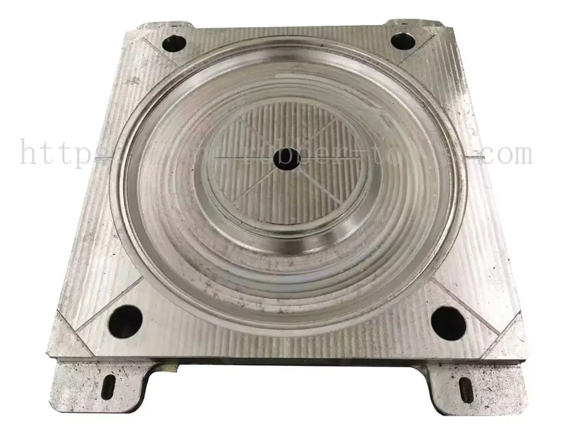 Large machined steel mould plate with a circular central cavity and guide pins